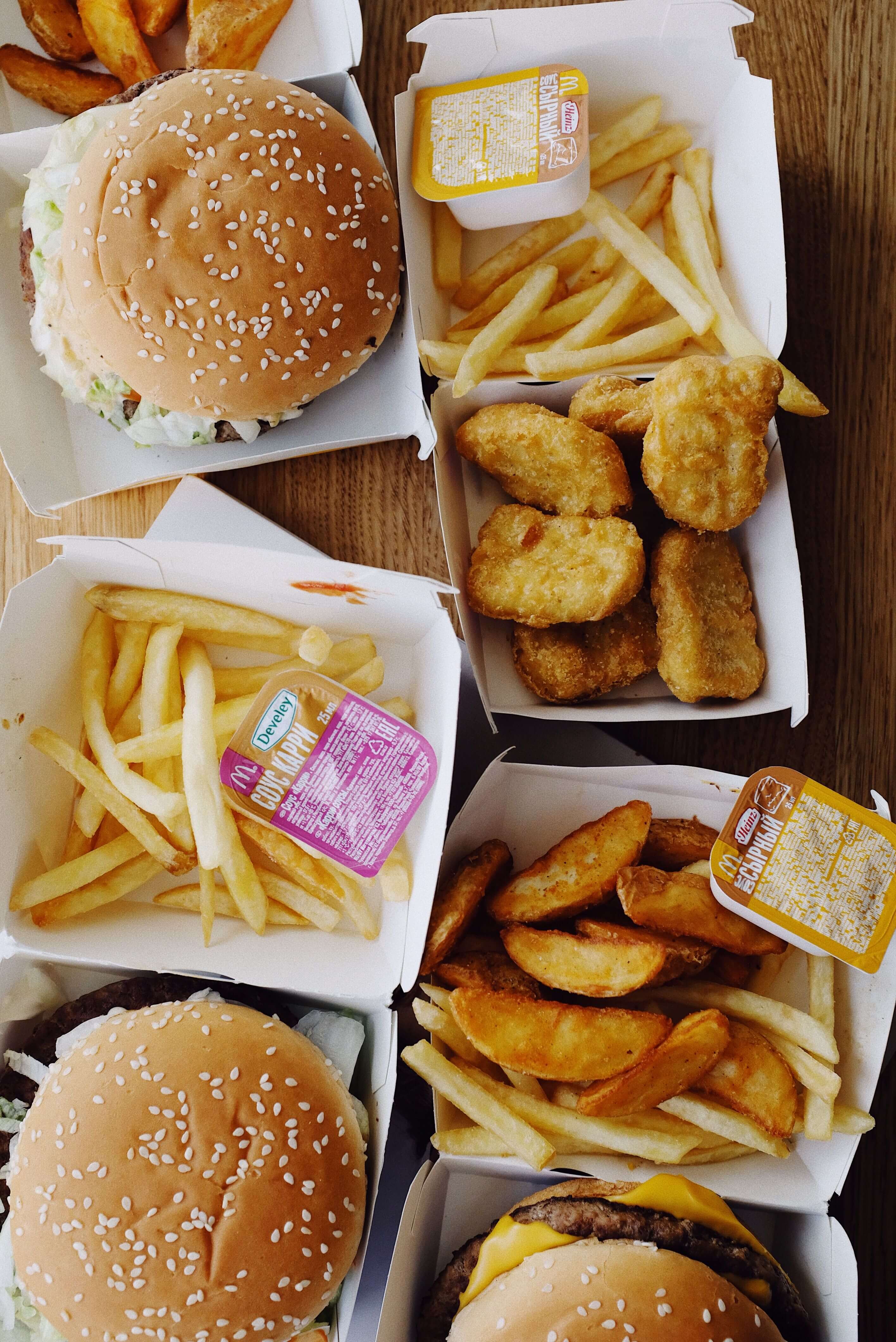 A meal deal box containing burgers, fries and drinks
