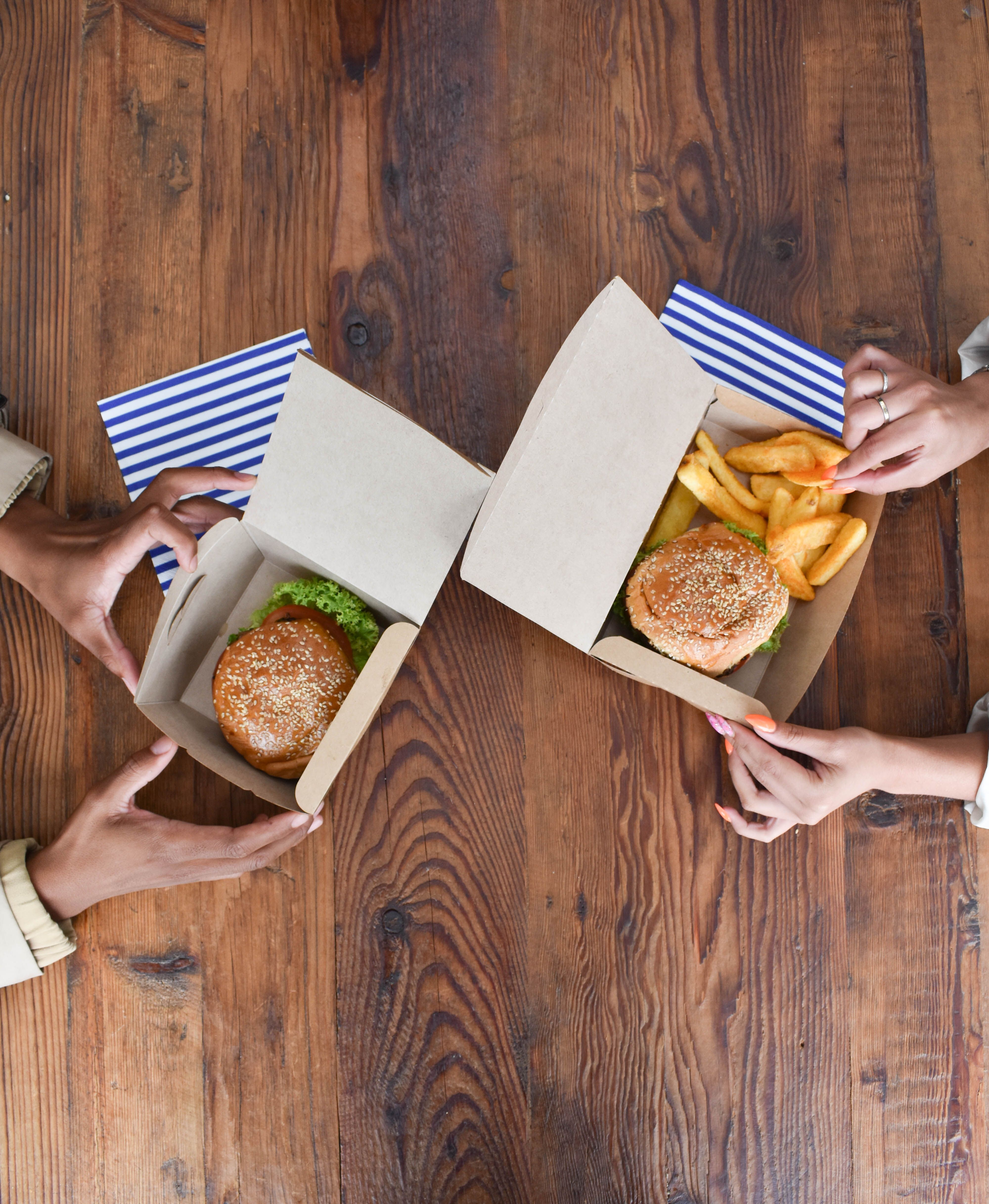 A meal deal with a burger, chips and a drink in a box