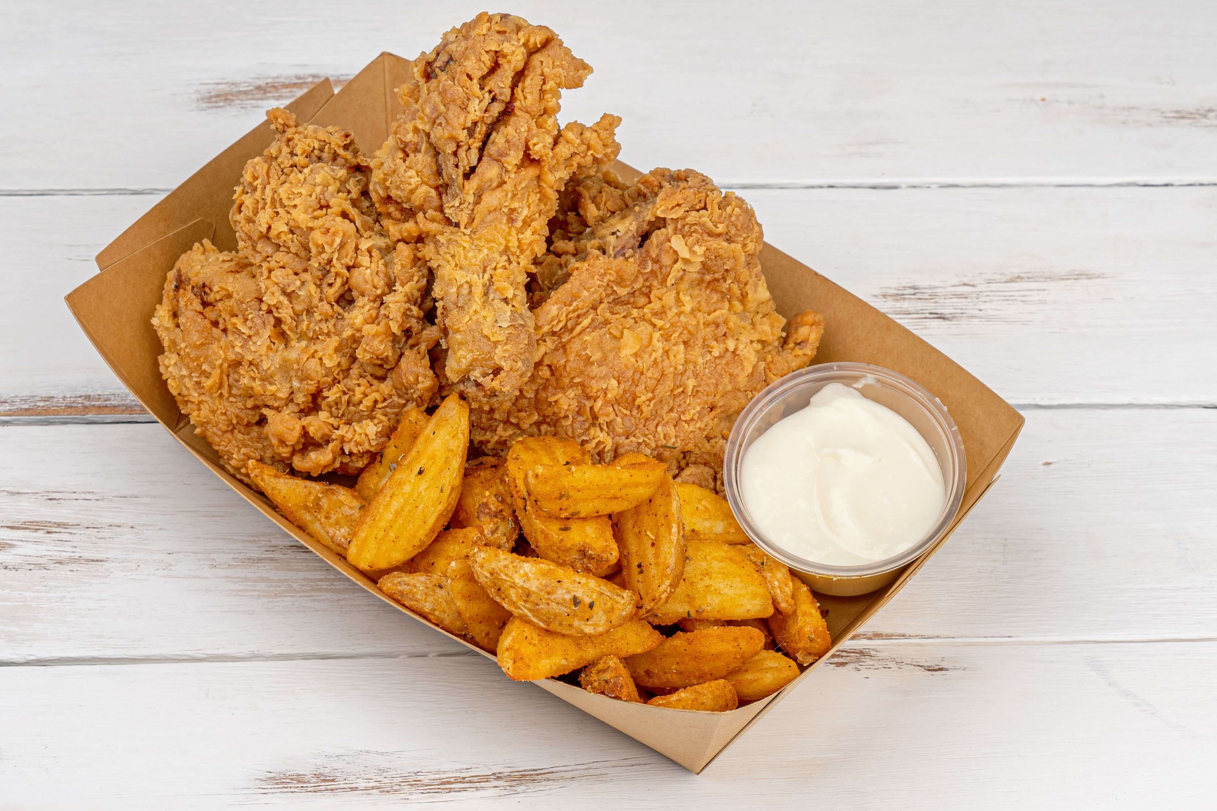 A meal deal with chicken, chips and a drink in a box
