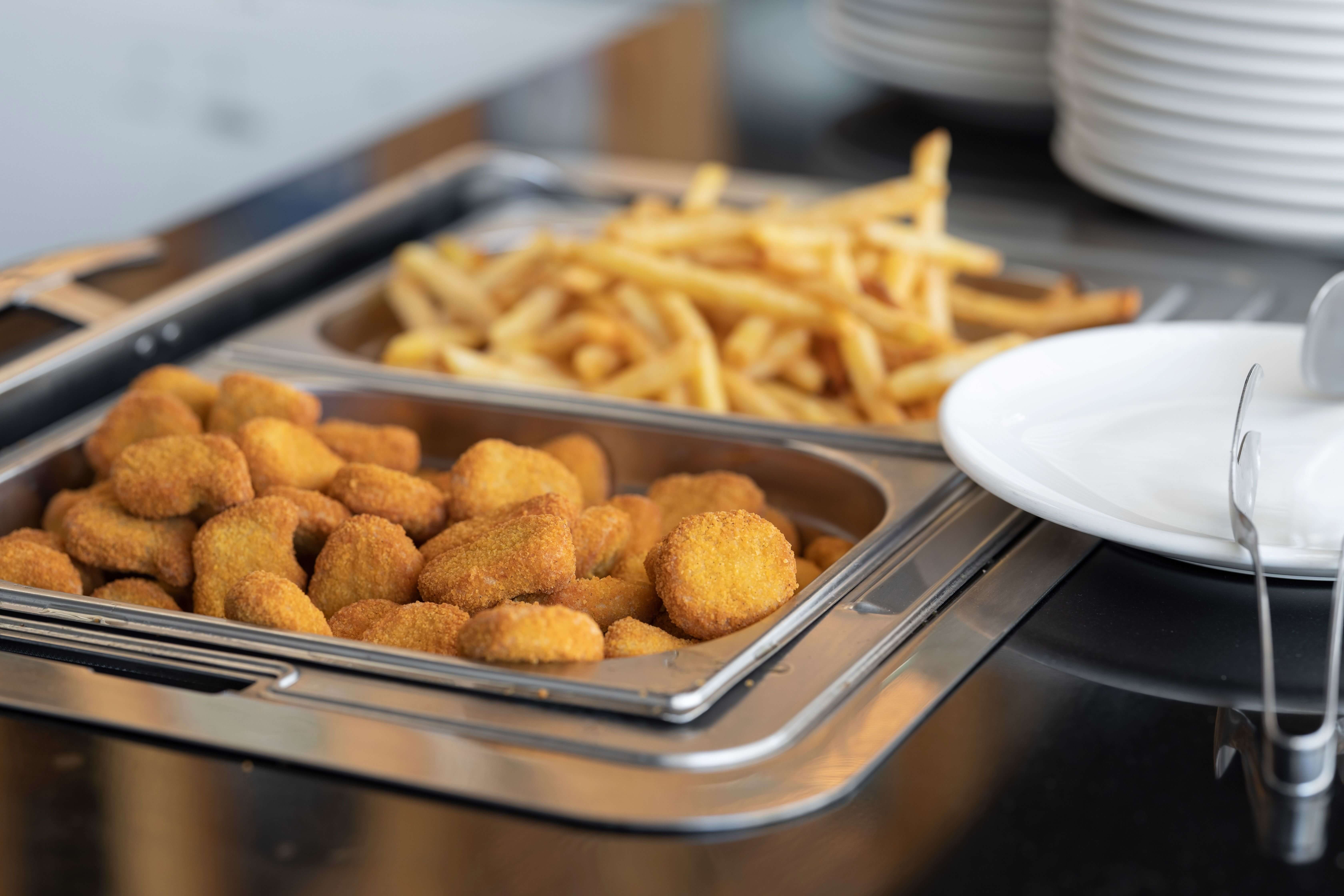 A smaller portion of chips and chicken nuggets